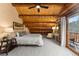 Spacious bedroom with log cabin features and balcony access at 878 American Way, Breckenridge, CO 80424