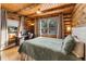 Cozy bedroom with log cabin walls and wooded views at 878 American Way, Breckenridge, CO 80424