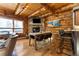 Rustic dining area with stone fireplace and wood beams at 878 American Way, Breckenridge, CO 80424