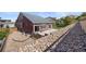 Landscaped backyard with retaining wall and gravel at 1178 Freedom Way, Castle Rock, CO 80109