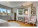 Spacious bedroom with large windows, dresser, and comfortable armchair at 12000 W 29Th Pl, Wheat Ridge, CO 80215