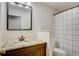 Clean bathroom with granite countertop, updated vanity, and shower/tub combo at 12000 W 29Th Pl, Wheat Ridge, CO 80215