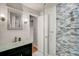 Updated bathroom with glass shower, modern vanity, and tile surround at 12000 W 29Th Pl, Wheat Ridge, CO 80215
