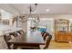 Bright dining room featuring a large wooden table and chandelier at 12000 W 29Th Pl, Wheat Ridge, CO 80215