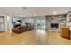 Bright Gathering room features hardwood floors, stone fireplace, and sliding glass doors to a patio at 12000 W 29Th Pl, Wheat Ridge, CO 80215