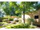 Landscaped backyard with stepping stones, grass, and mature trees at 2435 S Milwaukee St, Denver, CO 80210