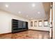Finished basement with stained concrete floors, built in shelving, and large windows at 2435 S Milwaukee St, Denver, CO 80210