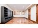 Finished basement room with stained concrete floor and three windows at 2435 S Milwaukee St, Denver, CO 80210