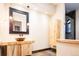 Modern bathroom with a unique wood vanity and walk-in shower at 2435 S Milwaukee St, Denver, CO 80210