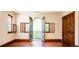 Bright bedroom with hardwood floors and French doors opening to a private balcony at 2435 S Milwaukee St, Denver, CO 80210