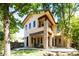 Back exterior view of two story home with patio and landscaping at 2435 S Milwaukee St, Denver, CO 80210