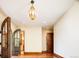 Well-lit interior hallway with hardwood floors and arched doorways leading to other rooms at 2435 S Milwaukee St, Denver, CO 80210