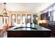 Large kitchen island with a curved green marble countertop and a farmhouse sink at 2435 S Milwaukee St, Denver, CO 80210