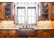 Elegant kitchen with copper farm sink, custom cabinetry, and stone countertops at 2435 S Milwaukee St, Denver, CO 80210