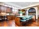 Open kitchen features a center island with green marble countertop and wooden cabinets at 2435 S Milwaukee St, Denver, CO 80210