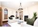 Elegant living room with hardwood floors, a fireplace, and French doors opening to a patio at 2435 S Milwaukee St, Denver, CO 80210