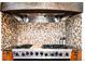 High-end gas range with custom stone hood and backsplash at 2435 S Milwaukee St, Denver, CO 80210