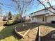 Private backyard with a patio, stone pathways, and mature trees at 6284 S Lima Way, Englewood, CO 80111