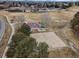 Aerial view of community park with basketball court, sand volleyball court, playground, and picnic area at 10589 Winterflower Way, Parker, CO 80134