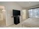 Main bedroom with TV stand and window coverings at 10589 Winterflower Way, Parker, CO 80134