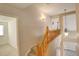 Upstairs hallway with wooden railing and lighting at 10589 Winterflower Way, Parker, CO 80134