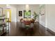 Modern dining room with a wood table, leather chairs, and yellow front door at 1253 Elizabeth St, Denver, CO 80206