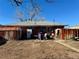 Backyard view of home with sheds and wooden fence at 3690 Leyden St, Denver, CO 80207