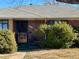 Brick ranch home with a covered entryway and landscaping at 3690 Leyden St, Denver, CO 80207