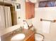 Neat bathroom with a vanity, toilet, shower, and linen storage at 2860 Ames St, Wheat Ridge, CO 80214