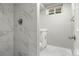 Basement bathroom with marble-look tile shower and white vanity at 10680 Carrol Ln, Northglenn, CO 80233