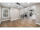 Bright dining room with hardwood floors and a modern chandelier at 12953 E Cornell Ave, Aurora, CO 80014