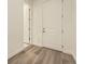 A bright and spacious hallway with wood-look flooring and white trim at 2966 S Quaker St, Morrison, CO 80465