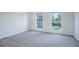 Empty bedroom with carpet and two windows at 12008 E Tennessee Dr, Aurora, CO 80012