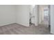 Empty bedroom with carpet flooring, an ensuite bathroom, and a view of another bedroom at 12008 E Tennessee Dr, Aurora, CO 80012