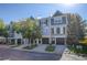 Row of townhomes with gray siding, black doors and stone accents at 12008 E Tennessee Dr, Aurora, CO 80012