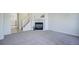 Living area with fireplace, carpeted floor, and view to the kitchen at 12008 E Tennessee Dr, Aurora, CO 80012