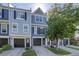 Gray townhome exterior with double-car garage and landscaping at 12008 E Tennessee Dr, Aurora, CO 80012