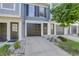 Gray townhome exterior with double-car garage and landscaping at 12008 E Tennessee Dr, Aurora, CO 80012