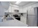 Modern kitchen featuring stainless steel appliances and gray countertops at 12008 E Tennessee Dr, Aurora, CO 80012
