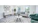 Living room with gray couch, green armchairs, and a coffee table at 12008 E Tennessee Dr, Aurora, CO 80012