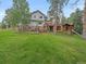 House exterior with a playset and green lawn at 3244 Elk View Dr, Evergreen, CO 80439