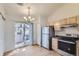 Bright kitchen with stainless steel appliances and light wood cabinets at 1758 Eagle St # C, Aurora, CO 80011