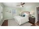 Bright bedroom with ceiling fan, hardwood floors, and en-suite bathroom at 12048 E Canal Dr, Aurora, CO 80011