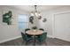 Dining area with a round wooden table and four green velvet chairs at 12048 E Canal Dr, Aurora, CO 80011