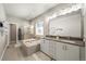 Elegant bathroom with double vanity, soaking tub, and shower at 6747 Raritan Dr, Denver, CO 80221