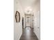 Bright and airy entryway with a modern light fixture and wood-look flooring at 6747 Raritan Dr, Denver, CO 80221