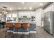 Modern kitchen with granite countertops, stainless steel appliances, and an island with seating at 6747 Raritan Dr, Denver, CO 80221