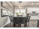 Bright dining room with a large table and chairs, adjacent to the kitchen at 6747 Raritan Dr, Denver, CO 80221