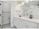 Modern bathroom with double vanity and large mirror at 461 Interlocken Blvd # 103, Broomfield, CO 80021