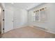 Bright and airy bedroom with neutral carpeting and large window at 461 Interlocken Blvd # 103, Broomfield, CO 80021